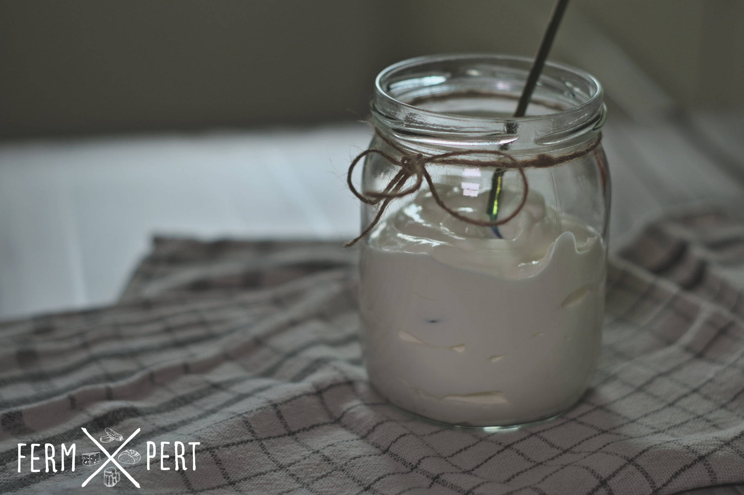 Photo of a jar of cream standing on a tea towel